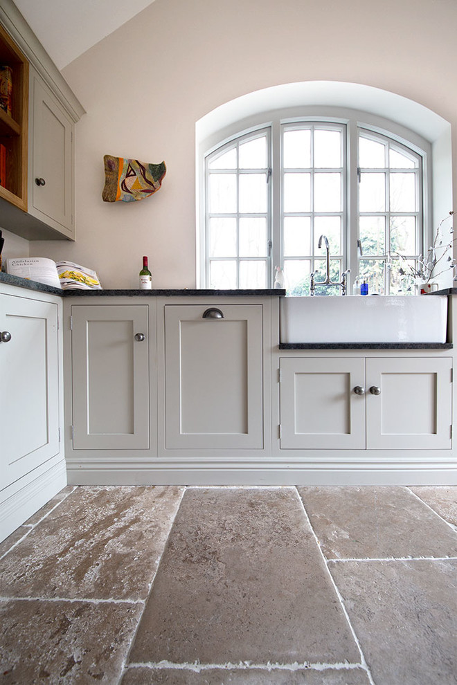 Inspiration for a medium sized farmhouse kitchen in Other with limestone flooring, an island and beige floors.