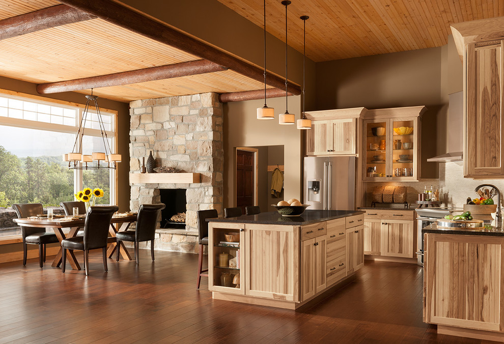 Open concept kitchen - rustic l-shaped open concept kitchen idea in DC Metro with an undermount sink, beaded inset cabinets, light wood cabinets, quartz countertops, white backsplash, stone tile backsplash and stainless steel appliances