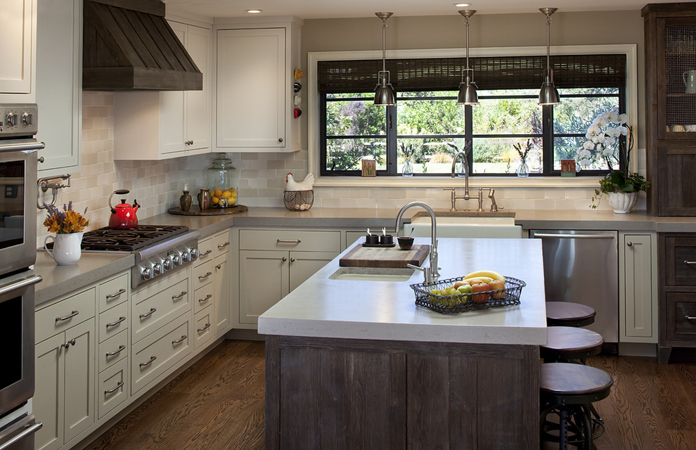Photo of a rustic kitchen in San Francisco with stainless steel appliances, a belfast sink, concrete worktops, beige splashback and metro tiled splashback.