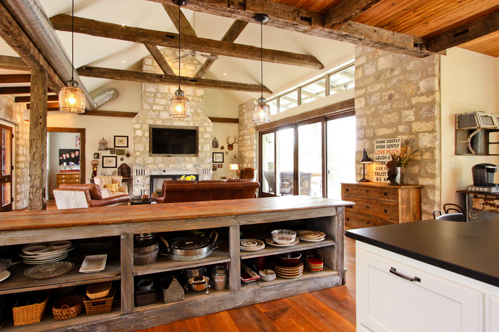 Example of a mountain style open concept kitchen design in Other with open cabinets and wood countertops