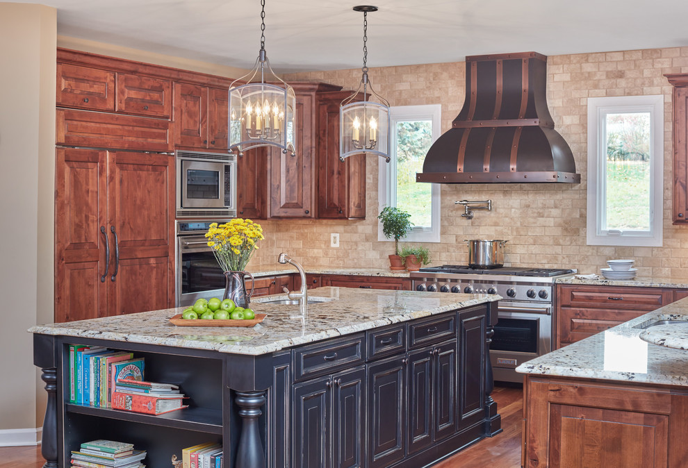 Eat-in kitchen - mid-sized rustic u-shaped medium tone wood floor eat-in kitchen idea in Baltimore with a single-bowl sink, raised-panel cabinets, medium tone wood cabinets, solid surface countertops, beige backsplash, subway tile backsplash, stainless steel appliances and an island