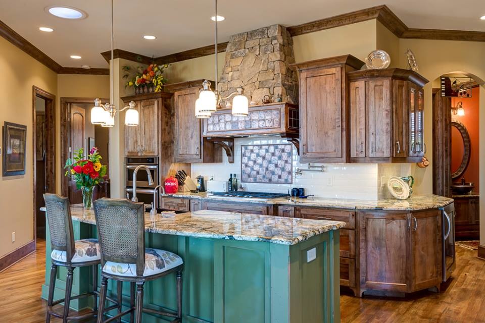 Inspiration for a large rustic single-wall medium tone wood floor and brown floor eat-in kitchen remodel in Other with a farmhouse sink, shaker cabinets, medium tone wood cabinets, granite countertops, metallic backsplash, subway tile backsplash, stainless steel appliances and an island
