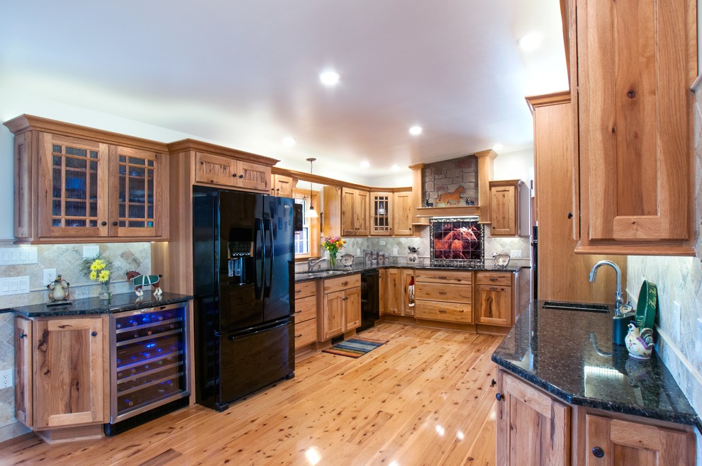This is an example of a large rustic u-shaped kitchen/diner in New York with light wood cabinets.