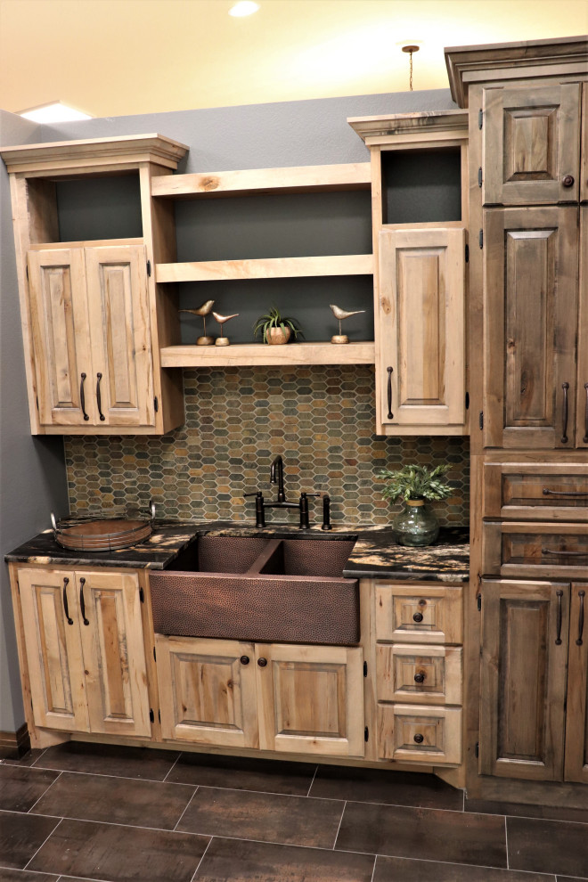 Mid-sized mountain style single-wall porcelain tile and brown floor kitchen photo in Other with a double-bowl sink, raised-panel cabinets, granite countertops, multicolored backsplash, slate backsplash, black countertops and light wood cabinets