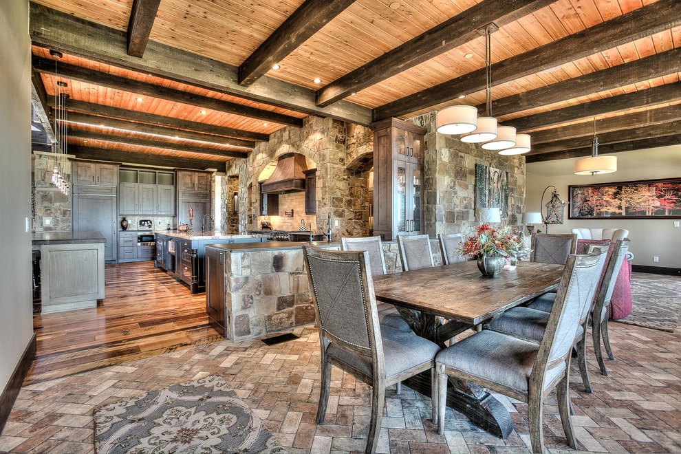 Inspiration for a huge rustic l-shaped medium tone wood floor eat-in kitchen remodel in Denver with an undermount sink, shaker cabinets, medium tone wood cabinets, granite countertops, beige backsplash, stone tile backsplash, stainless steel appliances and two islands