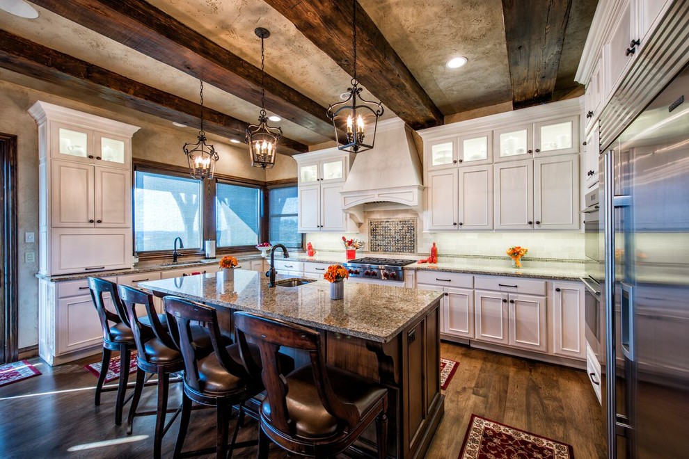 Inspiration for a large rustic u-shaped dark wood floor kitchen remodel in Other with an undermount sink, beaded inset cabinets, white cabinets, granite countertops, white backsplash, stainless steel appliances and an island