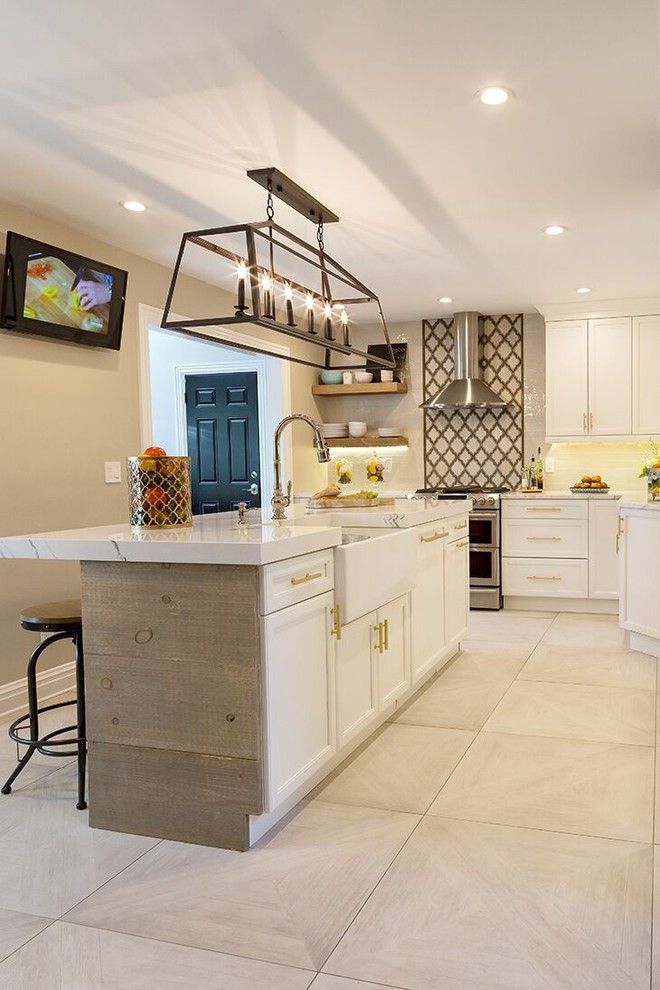 Eat-in kitchen - mid-sized rustic u-shaped porcelain tile eat-in kitchen idea in New York with a farmhouse sink, shaker cabinets, white cabinets, quartz countertops, white backsplash, porcelain backsplash, stainless steel appliances and an island