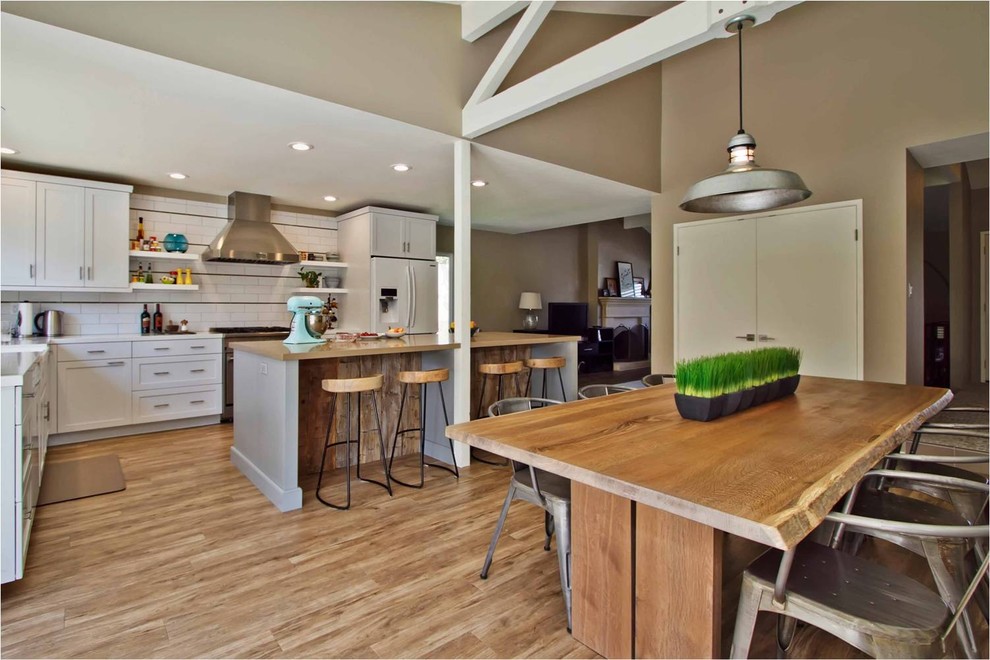 Transitional l-shaped open concept kitchen photo in San Diego with recessed-panel cabinets, white cabinets, white backsplash, subway tile backsplash and white appliances