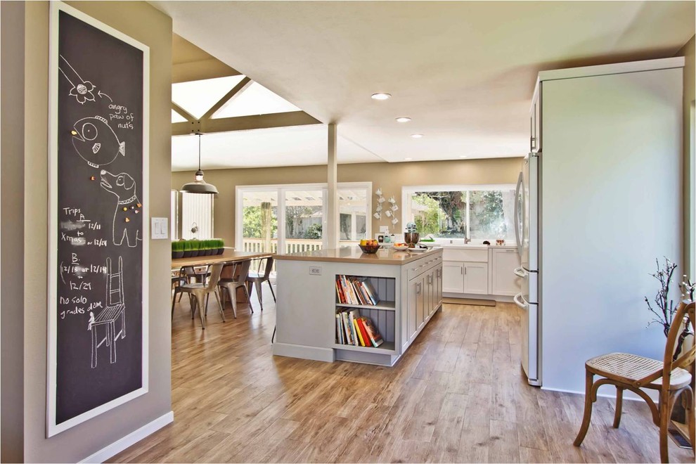 Open concept kitchen - contemporary l-shaped open concept kitchen idea in San Diego with a farmhouse sink, white cabinets and white appliances