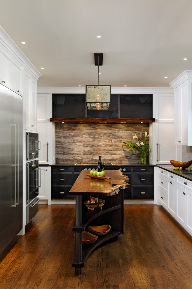 Eat-in kitchen - traditional u-shaped medium tone wood floor eat-in kitchen idea in DC Metro with white cabinets, stainless steel appliances, an island, an undermount sink, shaker cabinets, quartz countertops, multicolored backsplash and stone tile backsplash