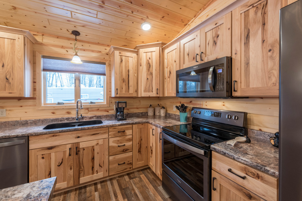 Photo of a medium sized rustic l-shaped kitchen/diner in Minneapolis with a submerged sink, shaker cabinets, medium wood cabinets, laminate countertops, stainless steel appliances, lino flooring, an island, multi-coloured floors and turquoise worktops.