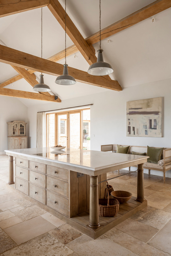 Design ideas for a large rustic galley open plan kitchen in Gloucestershire with a single-bowl sink, raised-panel cabinets, marble worktops, stone slab splashback, stainless steel appliances, limestone flooring, an island and light wood cabinets.