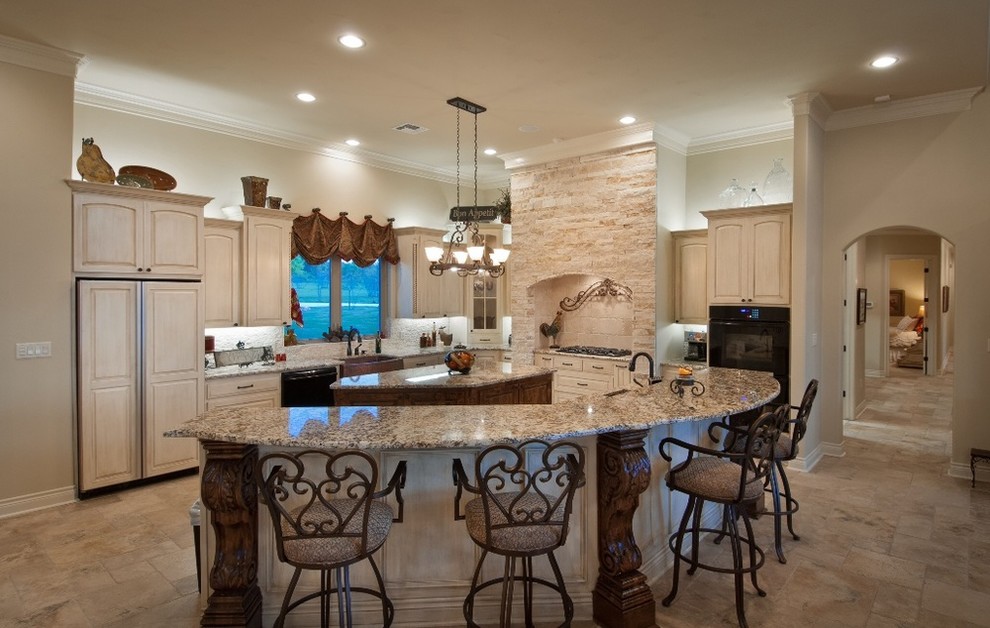 Inspiration for a timeless single-wall travertine floor eat-in kitchen remodel in Austin with a farmhouse sink, raised-panel cabinets, distressed cabinets, granite countertops, beige backsplash, stone tile backsplash, black appliances and two islands