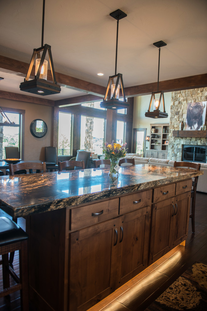 Photo of an expansive rustic u-shaped kitchen/diner in Other with a double-bowl sink, shaker cabinets, medium wood cabinets, granite worktops, metallic splashback, stainless steel appliances, medium hardwood flooring and multiple islands.