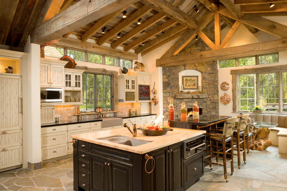 Inspiration for a timeless eat-in kitchen remodel in Other with a farmhouse sink, beige cabinets and an island