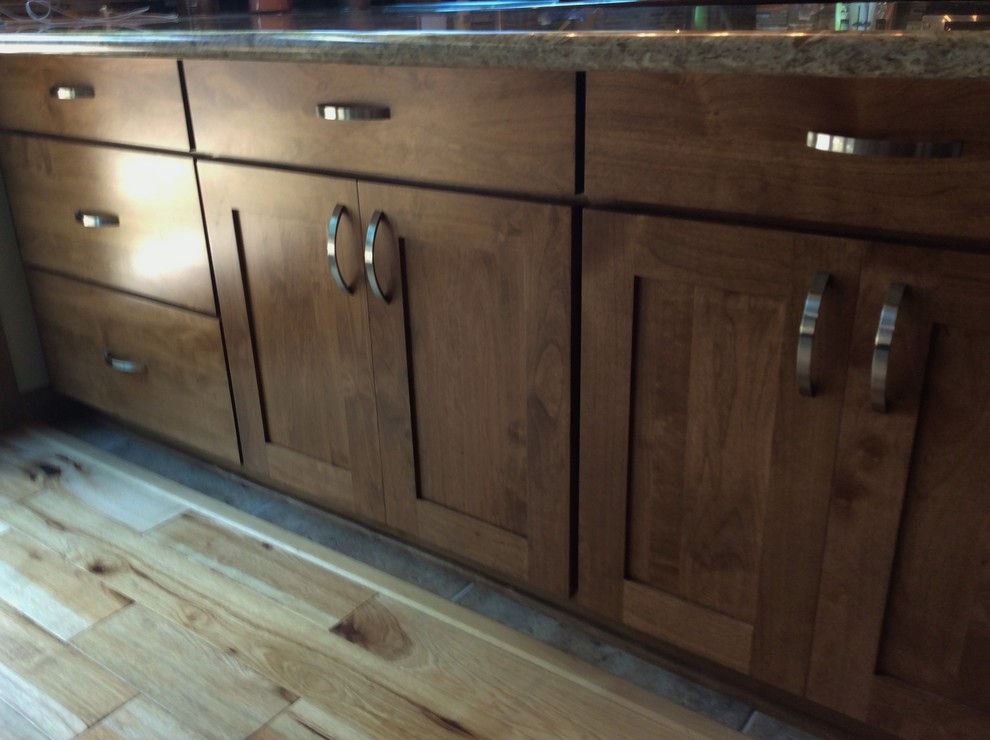 Imagen de cocina comedor rural con armarios estilo shaker, puertas de armario de madera oscura, encimera de cuarzo compacto y suelo de madera clara
