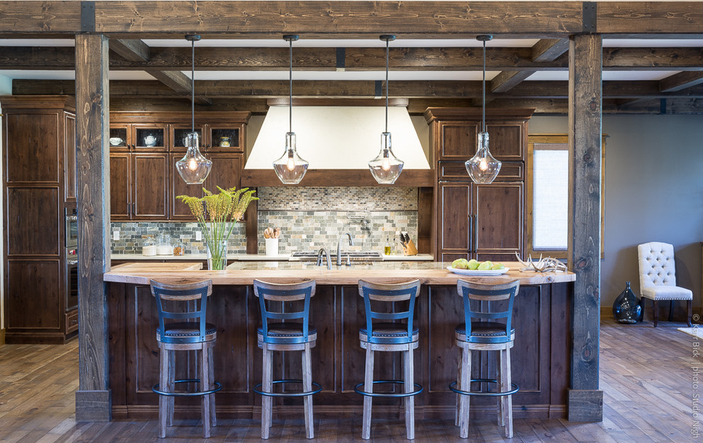 Inspiration for a large rustic l-shaped kitchen in St Louis with a built-in sink, flat-panel cabinets, medium wood cabinets, wood worktops, green splashback, marble splashback, integrated appliances, medium hardwood flooring, multiple islands and brown floors.