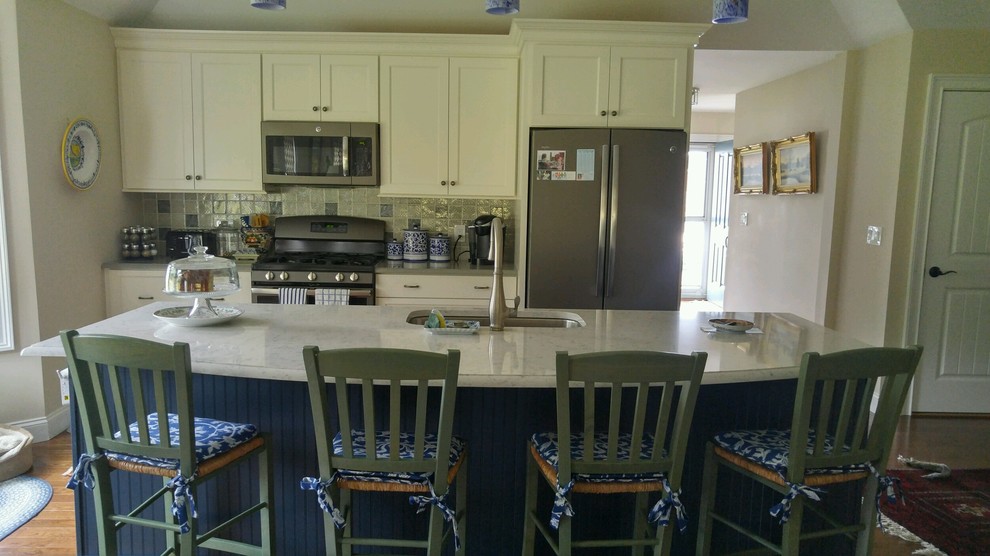 Photo of a medium sized traditional l-shaped open plan kitchen in Boston with a submerged sink, shaker cabinets, blue cabinets, stainless steel appliances, dark hardwood flooring and an island.