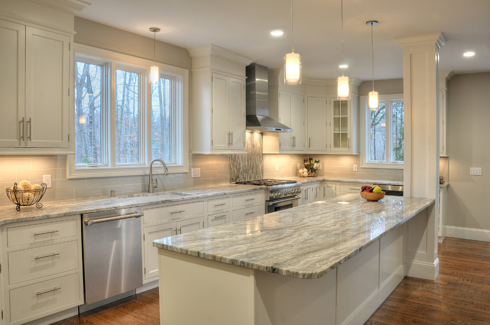 Inspiration for a large contemporary l-shaped medium tone wood floor and brown floor kitchen remodel in Boston with an undermount sink, beaded inset cabinets, white cabinets, quartzite countertops, gray backsplash, glass tile backsplash, stainless steel appliances and an island