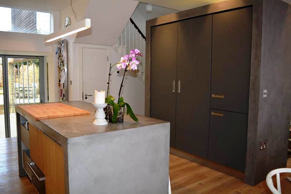 Foto på ett mellanstort rustikt kök, med släta luckor, grå skåp, en köksö, en enkel diskho, bänkskiva i betong, vitt stänkskydd, stänkskydd i glaskakel och rostfria vitvaror
