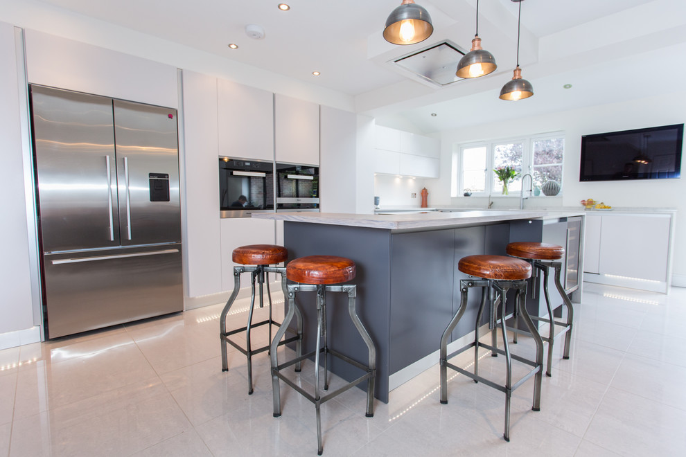 Photo of a large modern l-shaped open plan kitchen in London with flat-panel cabinets, grey cabinets, quartz worktops and an island.