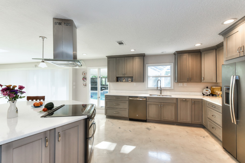 Inspiration for a large transitional single-wall concrete floor and multicolored floor open concept kitchen remodel in Jacksonville with a double-bowl sink, shaker cabinets, gray cabinets, quartzite countertops, white backsplash, stone slab backsplash, colored appliances and an island