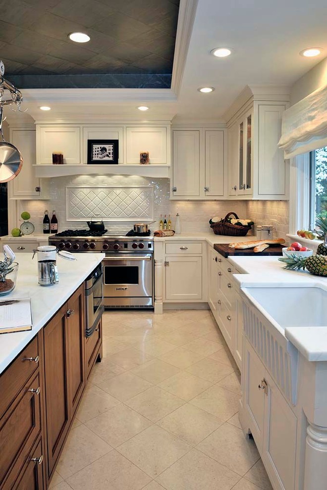 Exempel på ett stort klassiskt kök, med en rustik diskho, luckor med profilerade fronter, vita skåp, marmorbänkskiva, vitt stänkskydd, stänkskydd i keramik, rostfria vitvaror, klinkergolv i porslin och en köksö
