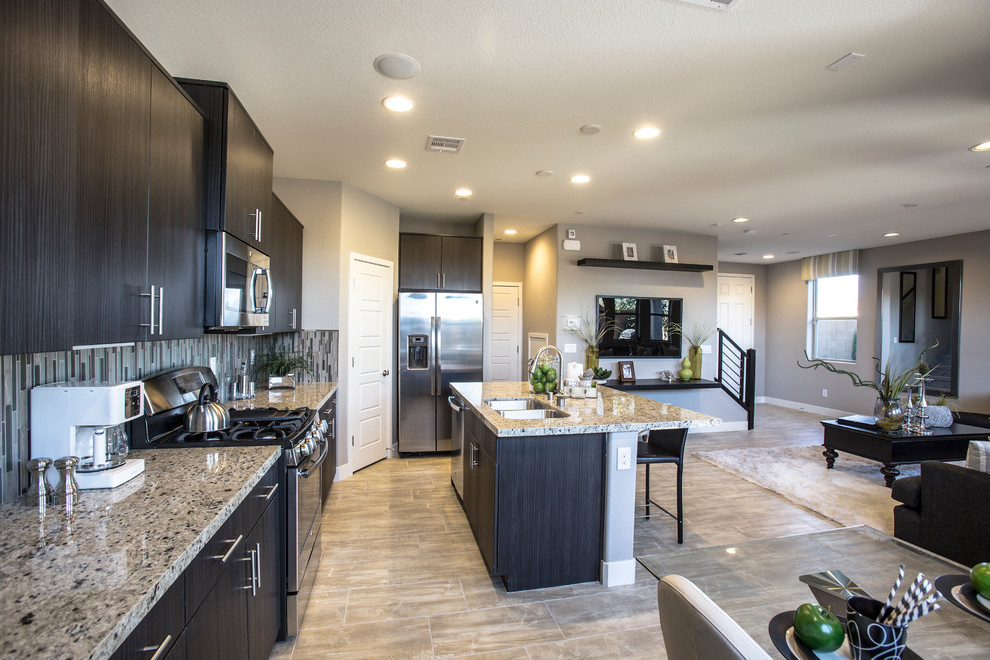 Eat-in kitchen - mid-sized eclectic l-shaped marble floor eat-in kitchen idea in Las Vegas with a double-bowl sink, flat-panel cabinets, dark wood cabinets, granite countertops, multicolored backsplash, matchstick tile backsplash, stainless steel appliances and an island