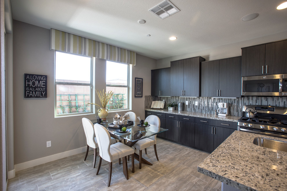 Example of a large eclectic l-shaped eat-in kitchen design in Las Vegas with a double-bowl sink, flat-panel cabinets, dark wood cabinets, granite countertops, multicolored backsplash, matchstick tile backsplash, stainless steel appliances and an island