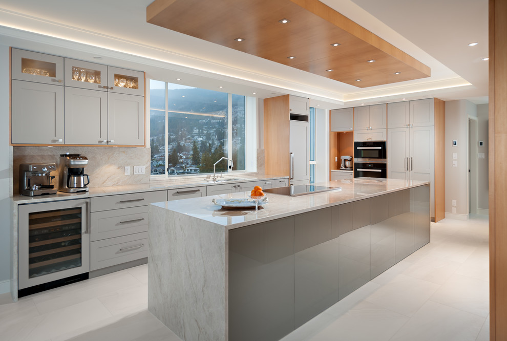 Large traditional l-shaped kitchen in Vancouver with grey cabinets, granite worktops, stainless steel appliances, ceramic flooring, an island and white floors.