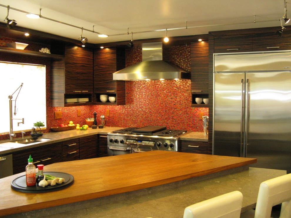 Large trendy l-shaped eat-in kitchen photo in San Diego with flat-panel cabinets, dark wood cabinets, red backsplash, mosaic tile backsplash, stainless steel appliances and an island