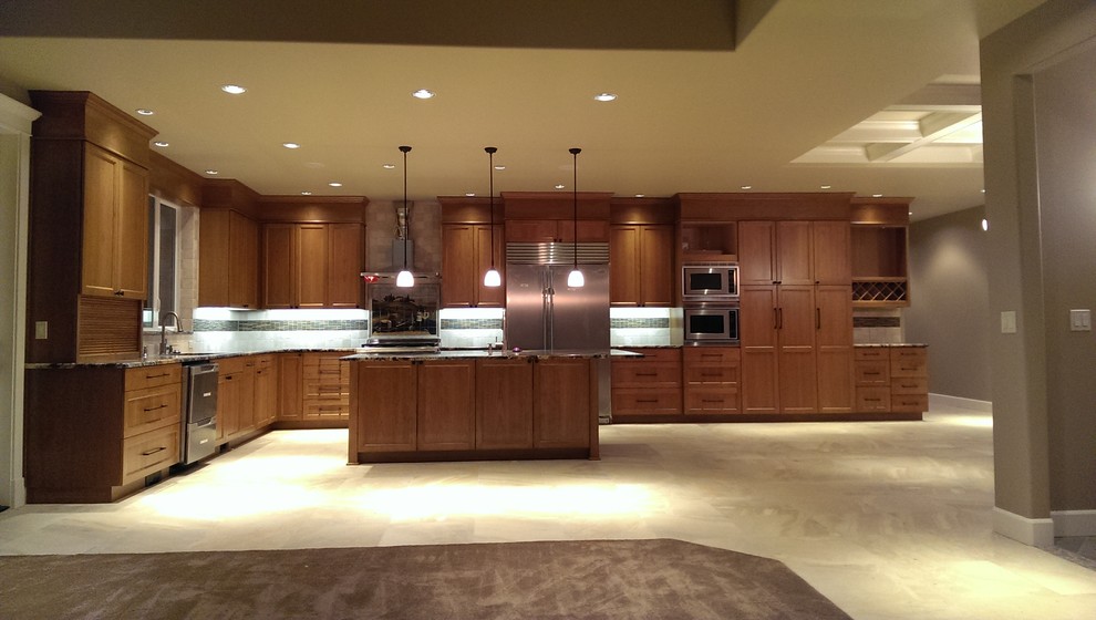 Arts and crafts l-shaped eat-in kitchen photo in Seattle with an undermount sink, recessed-panel cabinets, medium tone wood cabinets, granite countertops, beige backsplash, ceramic backsplash and stainless steel appliances