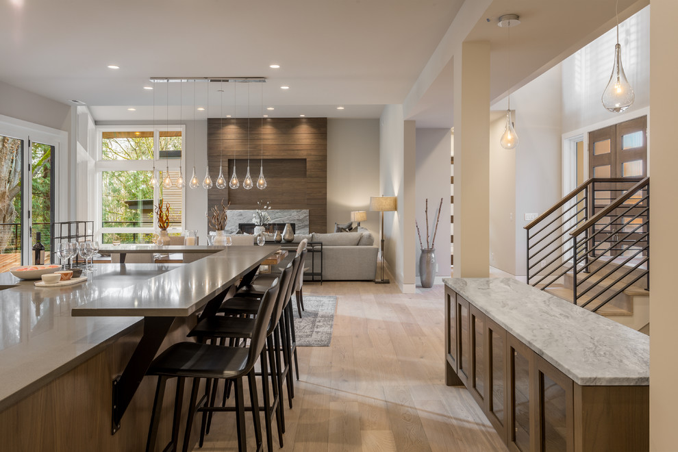 Contemporary open plan kitchen in Seattle with light hardwood flooring, beige floors and grey worktops.