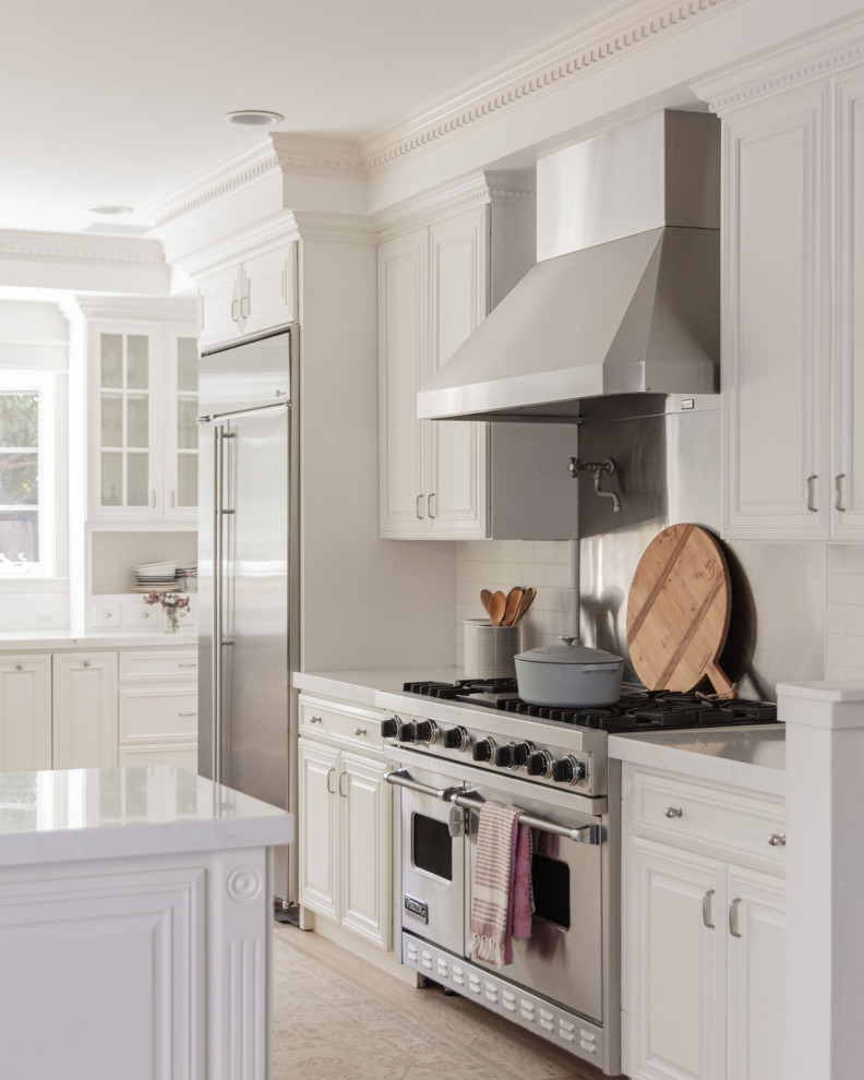Diseño de cocina contemporánea grande con puertas de armario blancas, encimera de granito, electrodomésticos de acero inoxidable, una isla y encimeras blancas