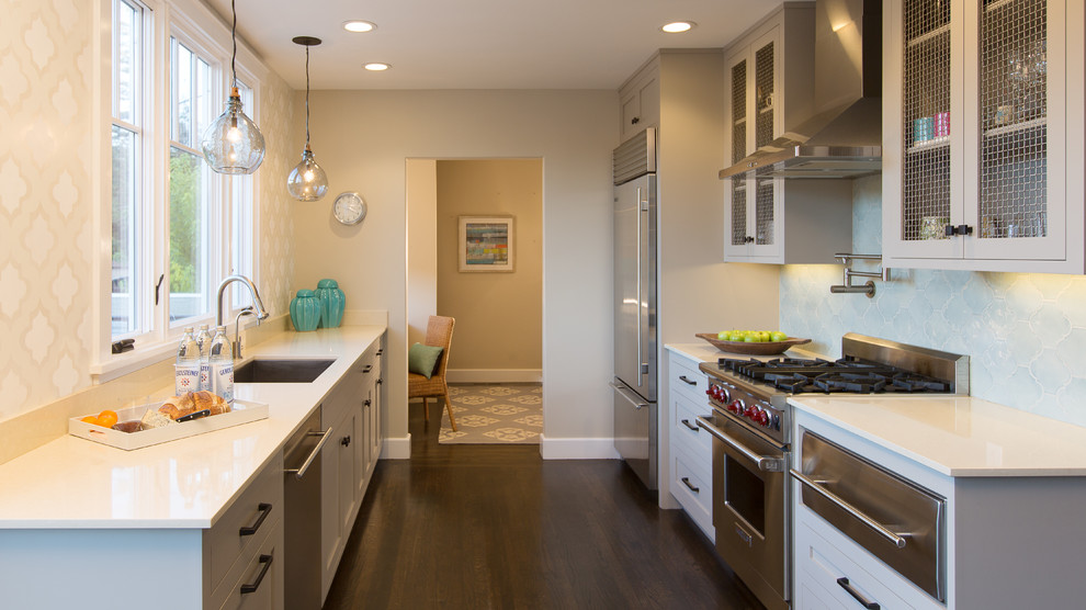 Design ideas for a traditional galley kitchen in San Francisco with a single-bowl sink, glass-front cabinets, grey cabinets and stainless steel appliances.