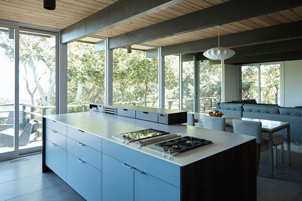 Example of a mid-sized 1960s ceramic tile open concept kitchen design in San Francisco with flat-panel cabinets, dark wood cabinets, solid surface countertops and two islands