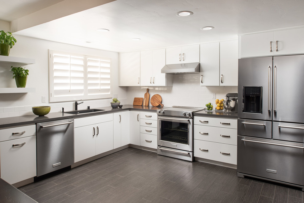 Eat-in kitchen - mid-sized contemporary l-shaped eat-in kitchen idea in San Diego with an undermount sink, flat-panel cabinets, white cabinets, quartz countertops, white backsplash, subway tile backsplash, stainless steel appliances and no island