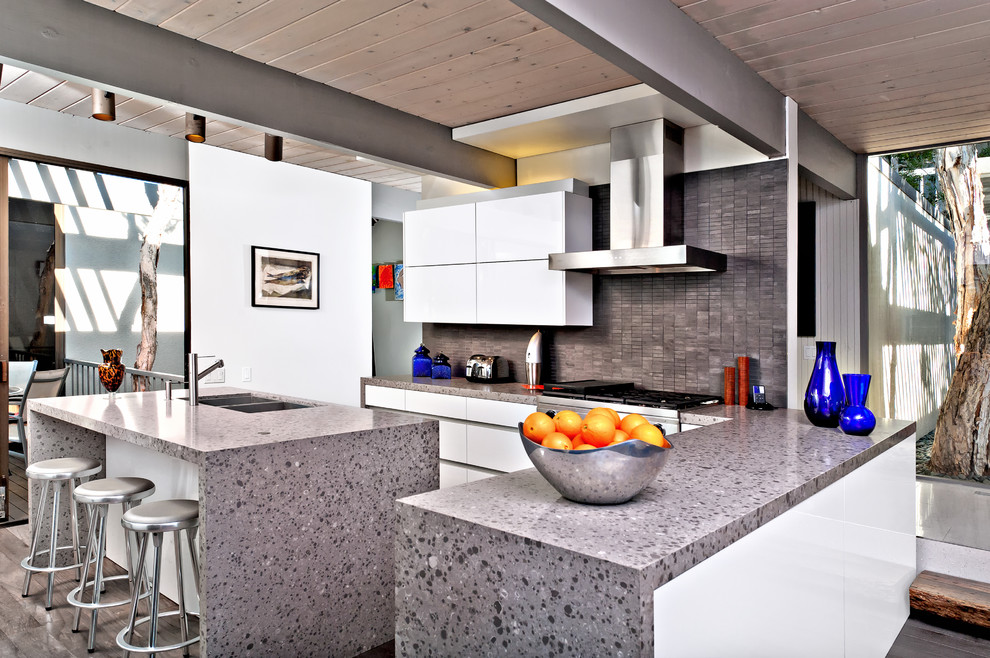 Design ideas for a modern l-shaped kitchen in San Diego with a double-bowl sink, flat-panel cabinets, white cabinets and grey splashback.