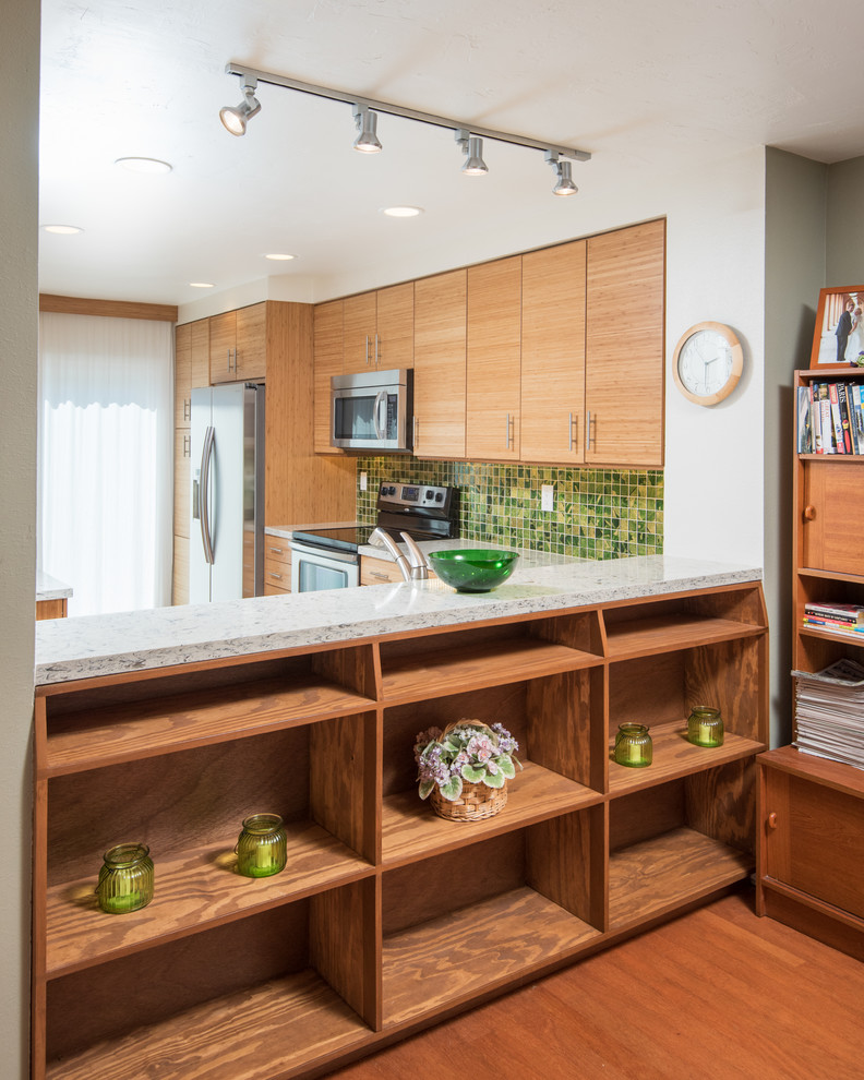 Photo of a medium sized contemporary l-shaped kitchen pantry in San Diego with a submerged sink, flat-panel cabinets, engineered stone countertops, green splashback, mosaic tiled splashback, stainless steel appliances and porcelain flooring.