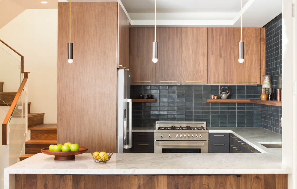 Contemporary u-shaped kitchen in San Francisco with a submerged sink, flat-panel cabinets, dark wood cabinets, grey splashback, metro tiled splashback, stainless steel appliances and a breakfast bar.