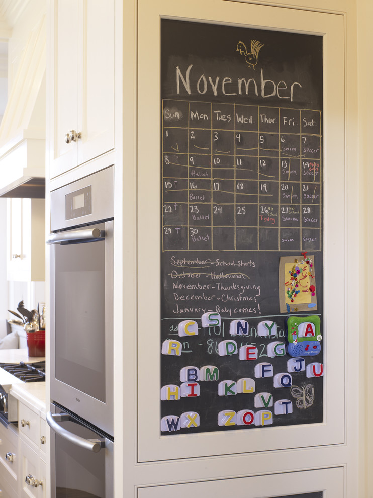 Trendy eat-in kitchen photo in San Francisco with white cabinets