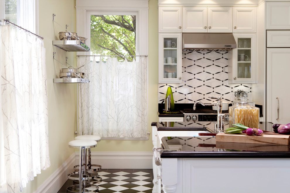 Mid-sized elegant l-shaped eat-in kitchen photo in San Francisco with a farmhouse sink, recessed-panel cabinets, white cabinets, paneled appliances, white backsplash, ceramic backsplash and an island