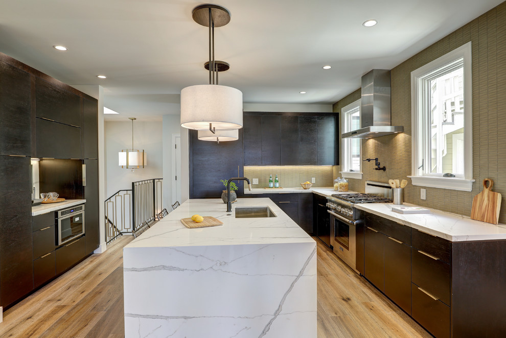 Mid-sized trendy u-shaped medium tone wood floor and brown floor eat-in kitchen photo in Other with flat-panel cabinets, dark wood cabinets, quartz countertops, stainless steel appliances, an island, white countertops, an undermount sink, beige backsplash and mosaic tile backsplash