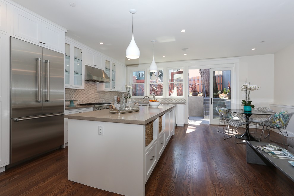 Inspiration for a contemporary l-shaped eat-in kitchen remodel in San Francisco with shaker cabinets, white cabinets, quartz countertops and stainless steel appliances