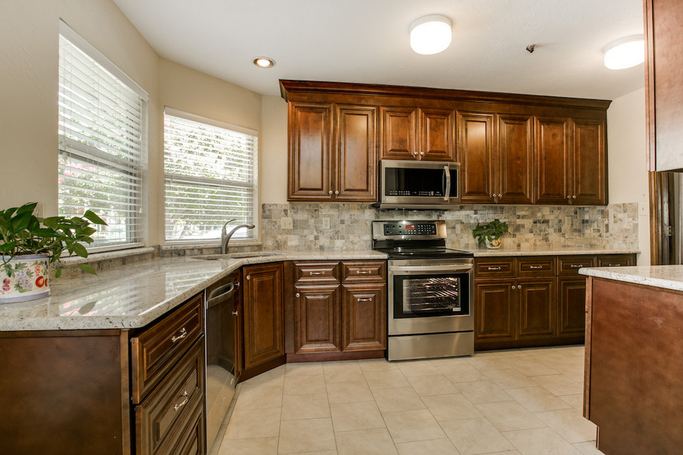 Mid-sized elegant u-shaped ceramic tile eat-in kitchen photo in Dallas with a double-bowl sink, recessed-panel cabinets, dark wood cabinets, granite countertops, multicolored backsplash, ceramic backsplash, stainless steel appliances and no island
