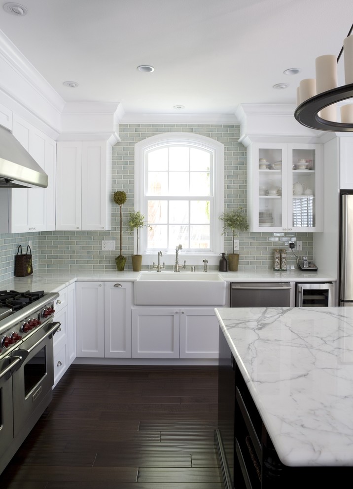Inspiration for a mid-sized timeless dark wood floor kitchen remodel in San Francisco with a farmhouse sink, stainless steel appliances, white countertops, shaker cabinets and white cabinets