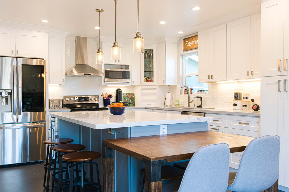 Eat-in kitchen - large modern l-shaped slate floor and black floor eat-in kitchen idea in San Francisco with an undermount sink, shaker cabinets, white cabinets, marble countertops, white backsplash, ceramic backsplash, stainless steel appliances, an island and white countertops