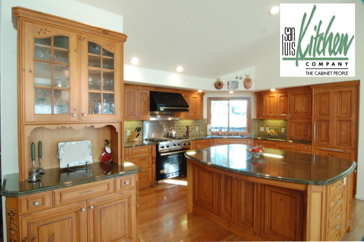 Example of a classic u-shaped eat-in kitchen design in San Luis Obispo with an undermount sink, light wood cabinets, granite countertops, green backsplash, ceramic backsplash and paneled appliances