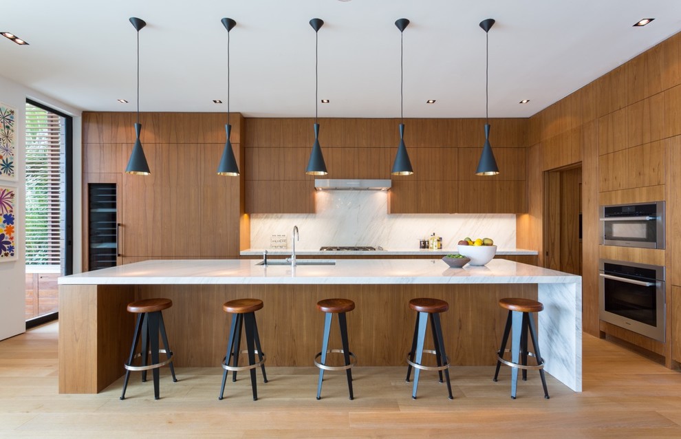 Example of a large trendy single-wall bamboo floor and beige floor eat-in kitchen design in Miami with an undermount sink, flat-panel cabinets, medium tone wood cabinets, marble countertops, multicolored backsplash, marble backsplash, stainless steel appliances and an island