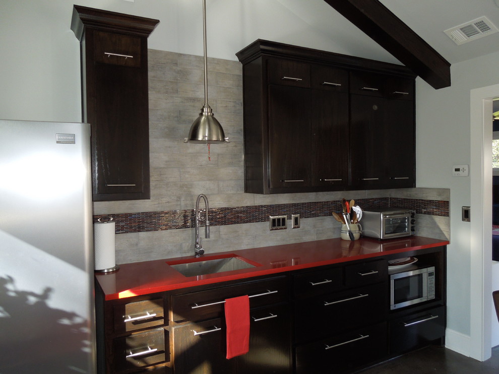 Inspiration for a transitional eat-in kitchen remodel in Dallas with a single-bowl sink, flat-panel cabinets, dark wood cabinets, quartzite countertops and multicolored backsplash